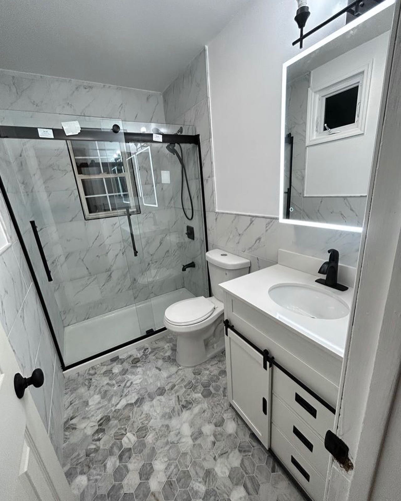 Bathroom remodel — modern marble walk-in shower with frameless glass