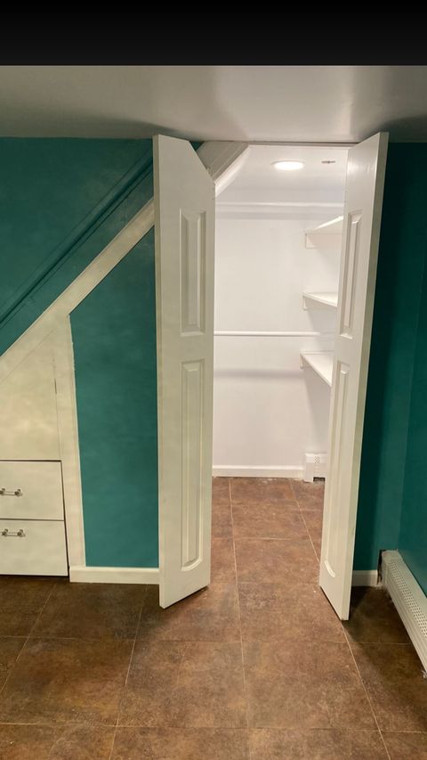 Custom reach-in closet with paneled doors