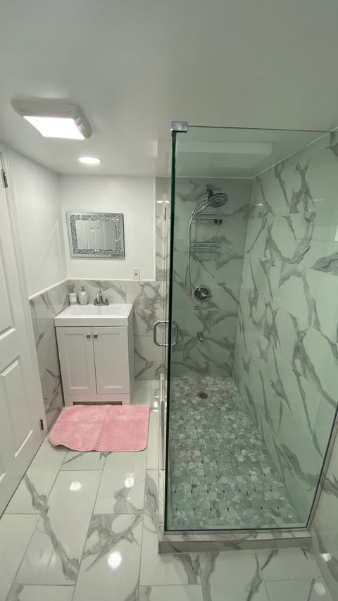 Bathroom remodel — geometric tile feature wall with white vanity