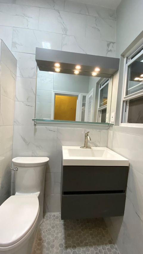 Bathroom remodel — walk-in shower with marble surround