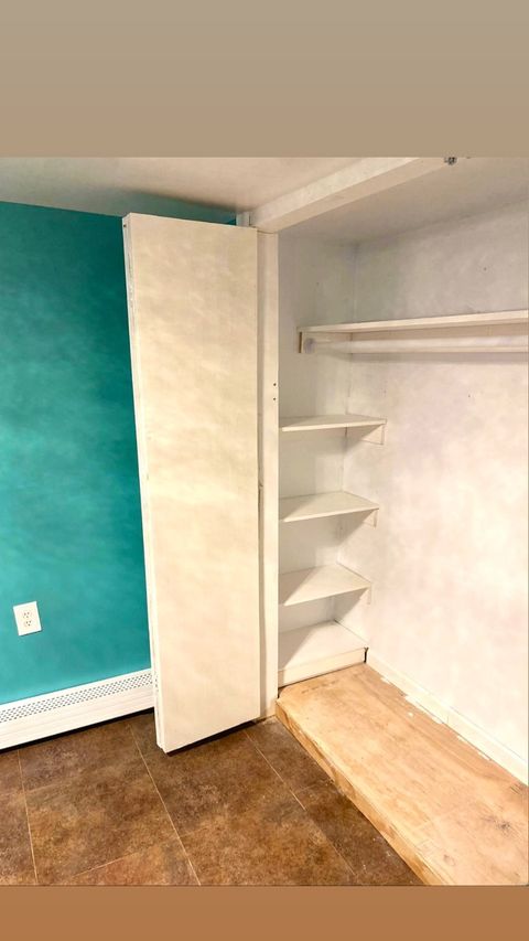 Walk-in closet with island and integrated lighting