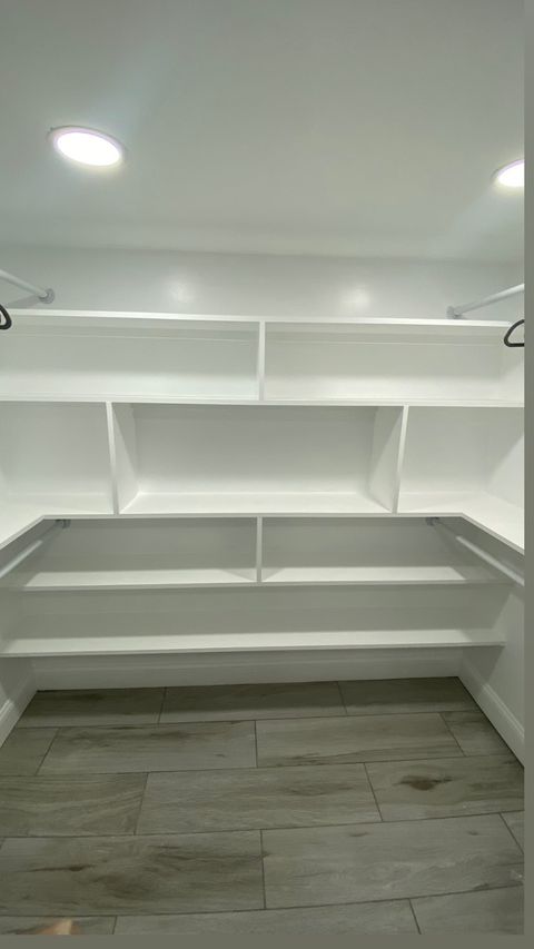 Custom closet build with floor-to-ceiling shelving