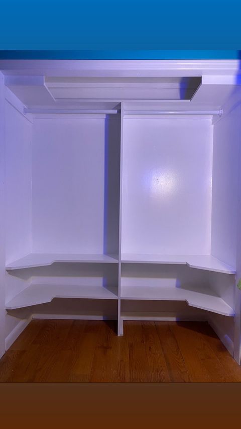 Walk-in closet with mirror and integrated lighting